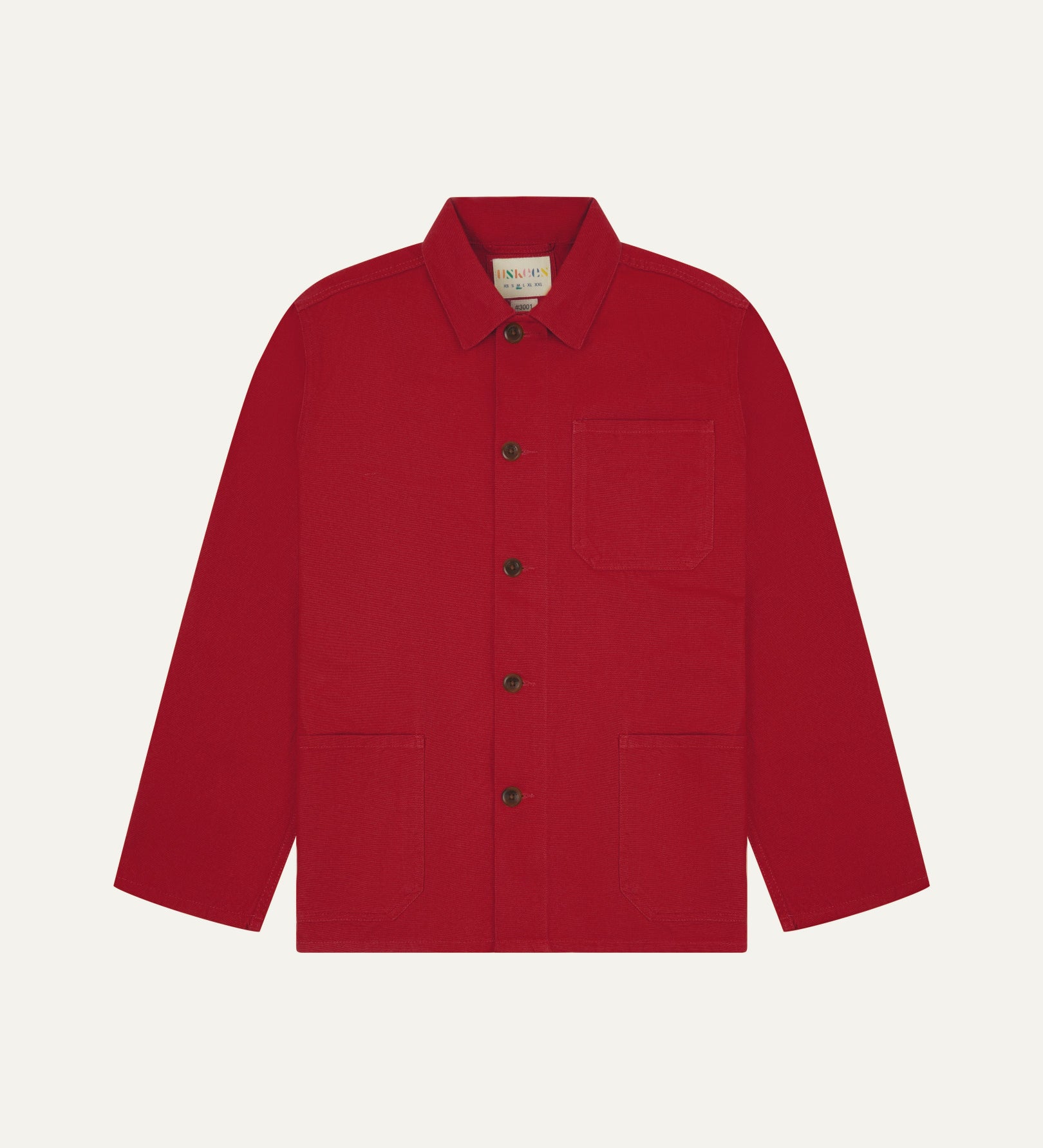 Front flat shot of berry red, buttoned organic cotton overshirt. Clear view of chest and hip pockets, corozo buttons and simple, boxy shape.