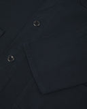 View of the mid-section and sleeve of the 3001 Uskees button-down drill overshirt in dark blue (blueberry) with focus on cuff, placket and hip pocket.