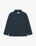 Front flat shot of blueberry, buttoned ripstop overshirt. Clear view of chest and hip pockets, corozo buttons and Uskees branding label.