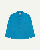 Front flat shot of bright blue, buttoned organic cotton overshirt. Clear view of chest and hip pockets, corozo buttons and Uskees branding label.