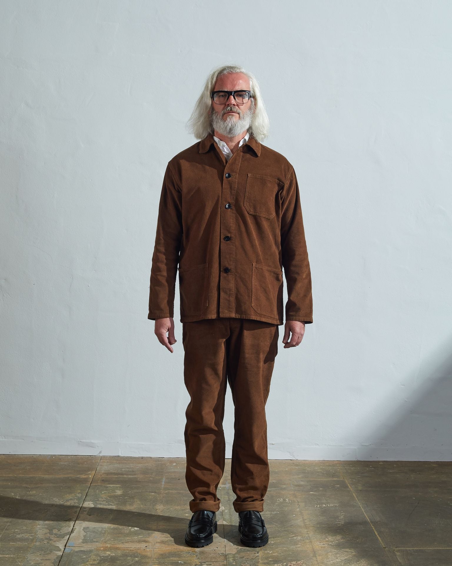 Full-length front view of model wearing #3001, brown corduroy overshirt paired with matching Uskees brown cord pants.