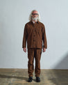 Full-length front view of model wearing #3001, brown corduroy overshirt paired with matching Uskees brown cord pants.