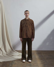 Full-length front view of model wearing #3001, brown over shirt.
