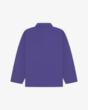 Back view of purple, buttoned organic cotton overshirt with view of reinforced elbow area and boxy silhouette.