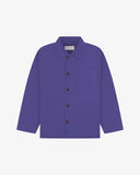 Front flat shot of purple, buttoned organic cotton overshirt. Clear view of chest and hip pockets, corozo buttons and simple, boxy shape.