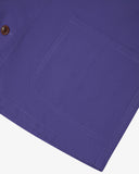 Closer view of purple, buttoned organic cotton overshirt from Uskees. Focus on hem, placket, hip pocket and corozo buttons.