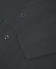 View of the mid-section and sleeve of the 3001 Uskees button-down drill overshirt in charcoal-grey with focus on cuff, placket and hip pocket.