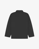 Back view of charcoal-grey, buttoned organic cotton overshirt with view of reinforced elbow area and boxy silhouette.