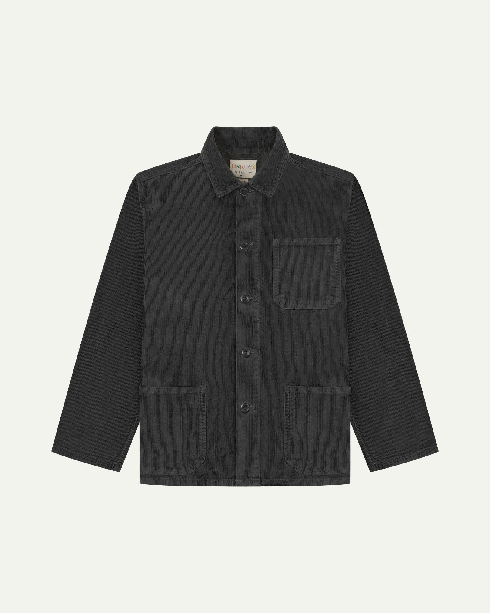 Front flat shot of charcoal-grey, buttoned corduroy overshirt. Clear view of chest and hip pockets, corozo buttons and Uskees branding label.