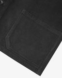 Closer view of mid section of charcoal-grey, buttoned corduroy overshirt from Uskees. Focus on pocket, corozo button and corduroy texture.