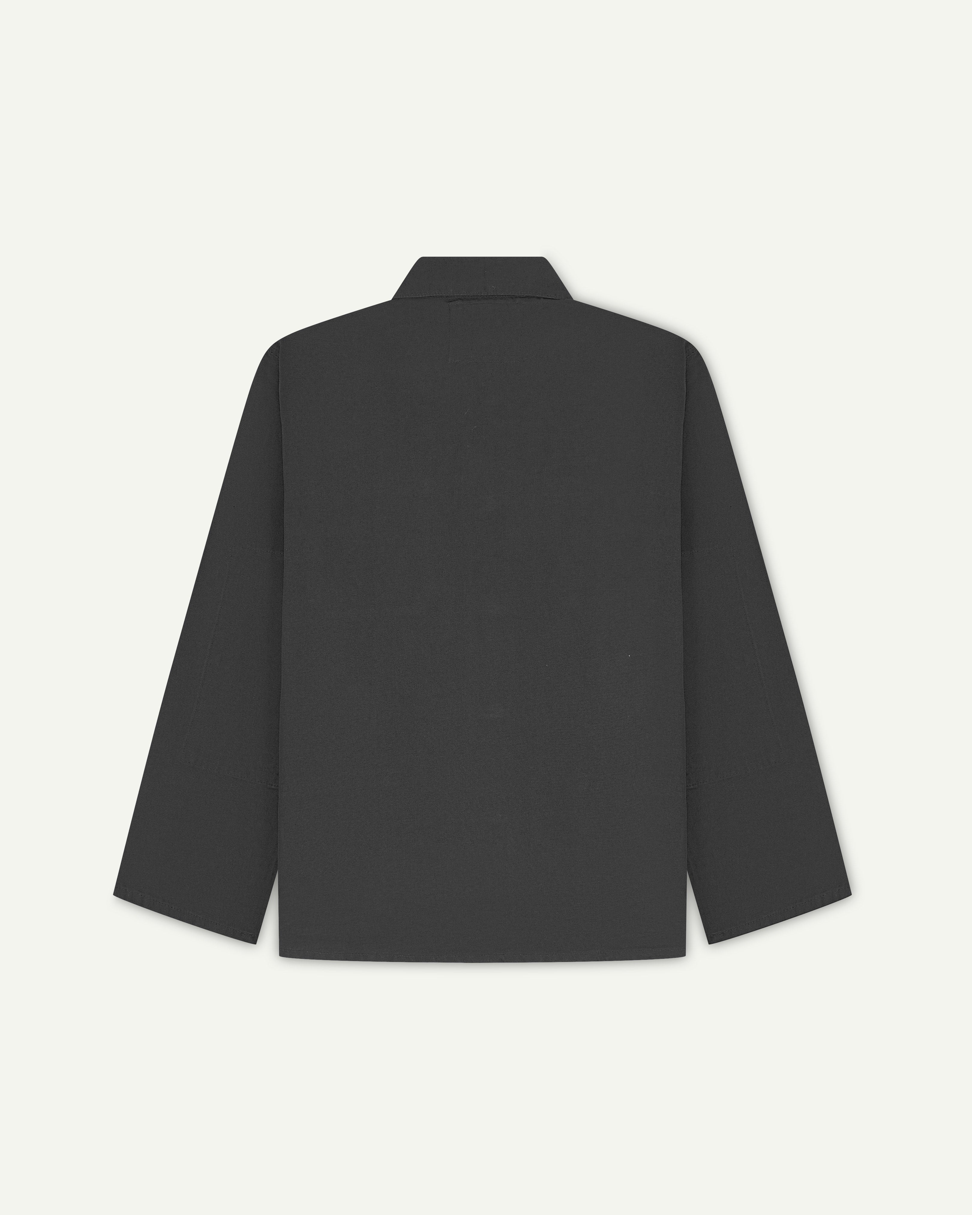 Back view of charcoal-grey, buttoned organic cotton overshirt with view of reinforced elbow area and boxy silhouette.