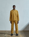 Full-length front view of model wearing #3001, citronella-yellow corduroy overshirt paired with matching Uskees cord pants.