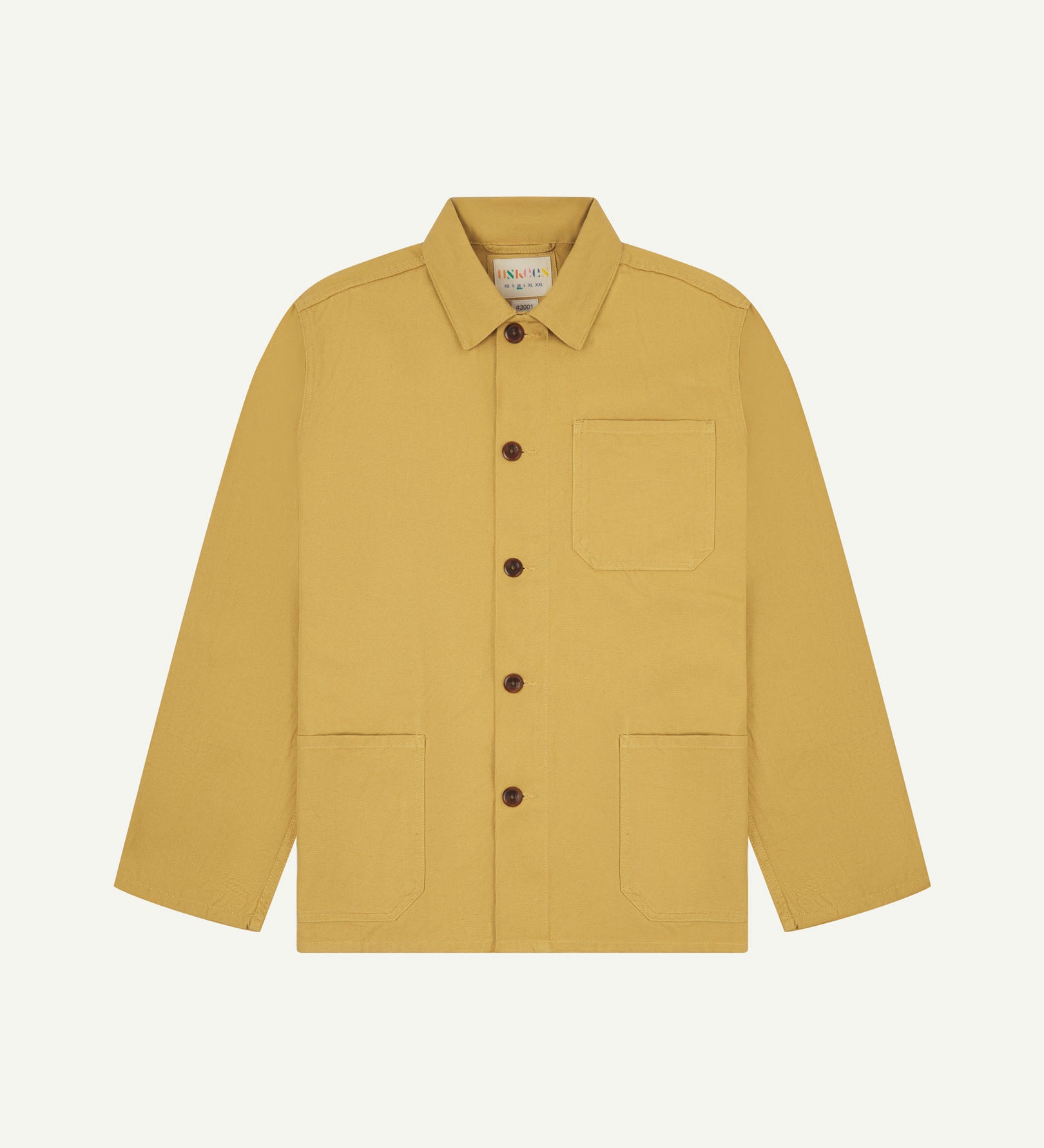 Front flat shot of yellow (citronella), buttoned organic cotton overshirt. Clear view of chest and hip pockets, corozo buttons and Uskees branding label.