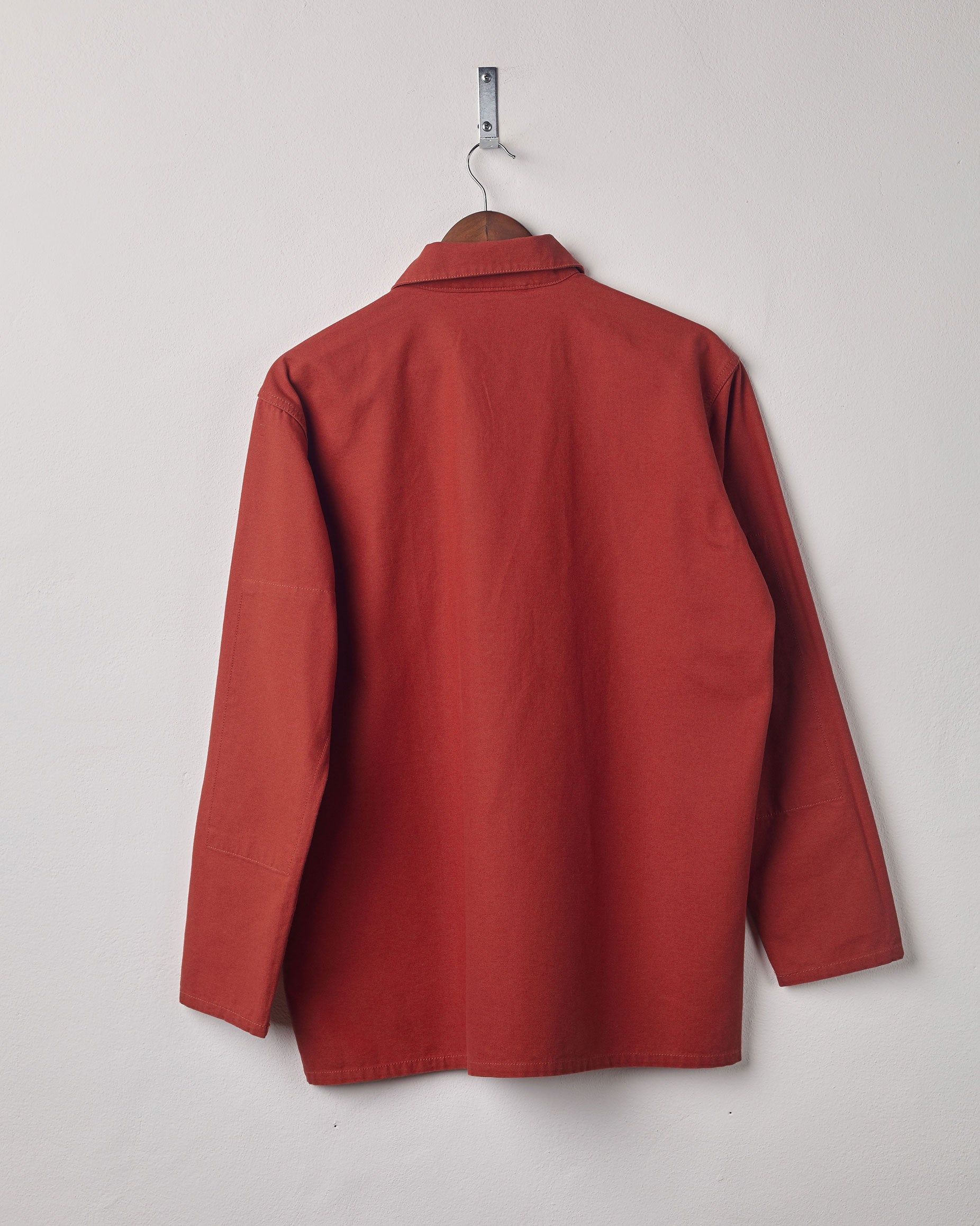 Full-length rear view of #3001, 'clay-red' coloured over shirt with reinforced elbows.
