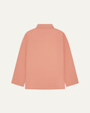 Back view of pink-orange (coral), buttoned organic cotton overshirt with view of reinforced elbow area and boxy silhouette.