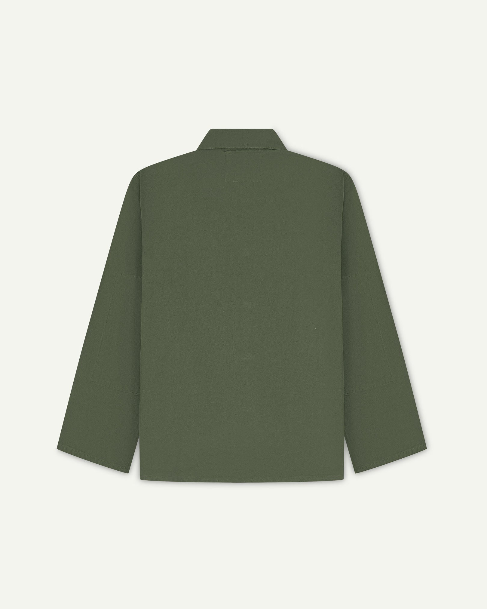 Back view of coriander-green, buttoned organic cotton overshirt with view of reinforced elbow area and boxy silhouette.