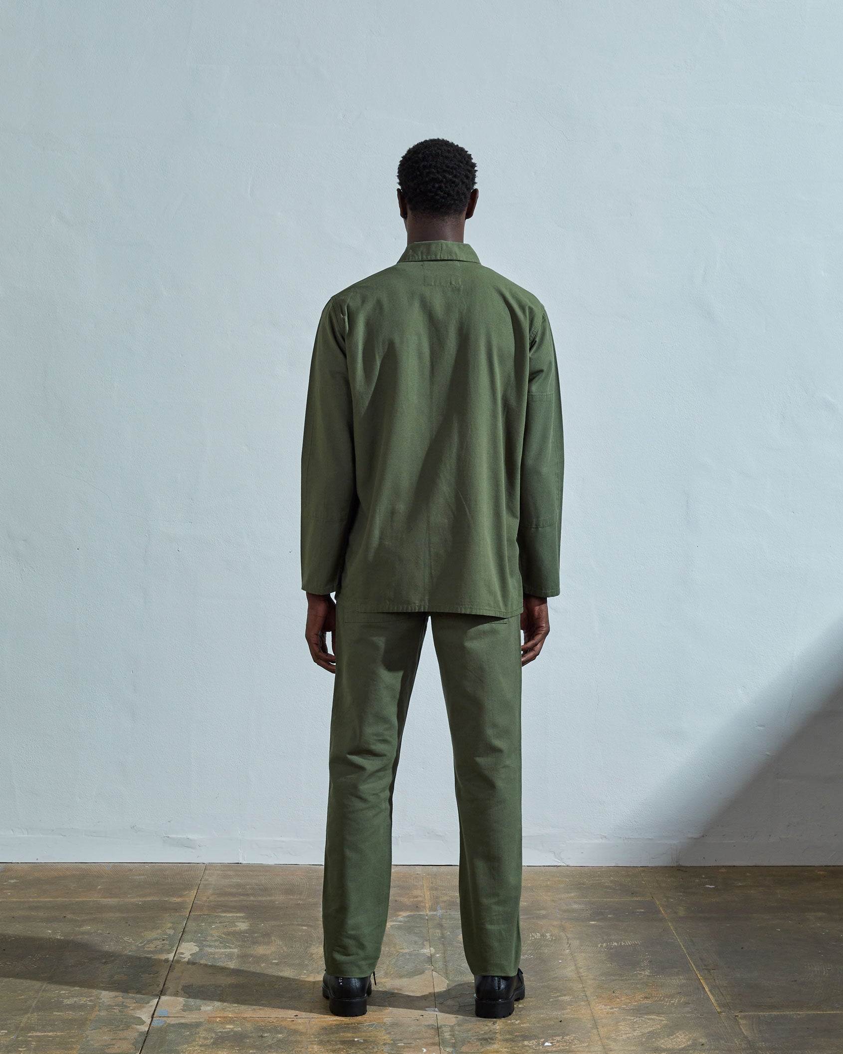 Full-length reverse wearing #3001, 'coriander-green' organic cotton over shirt with view of reinforced elbows and boxy silhouette.