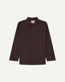 Front flat shot of burgundy-brown, buttoned drill overshirt. Clear view of corozo buttons, 3 pockets and Uskees branding label.