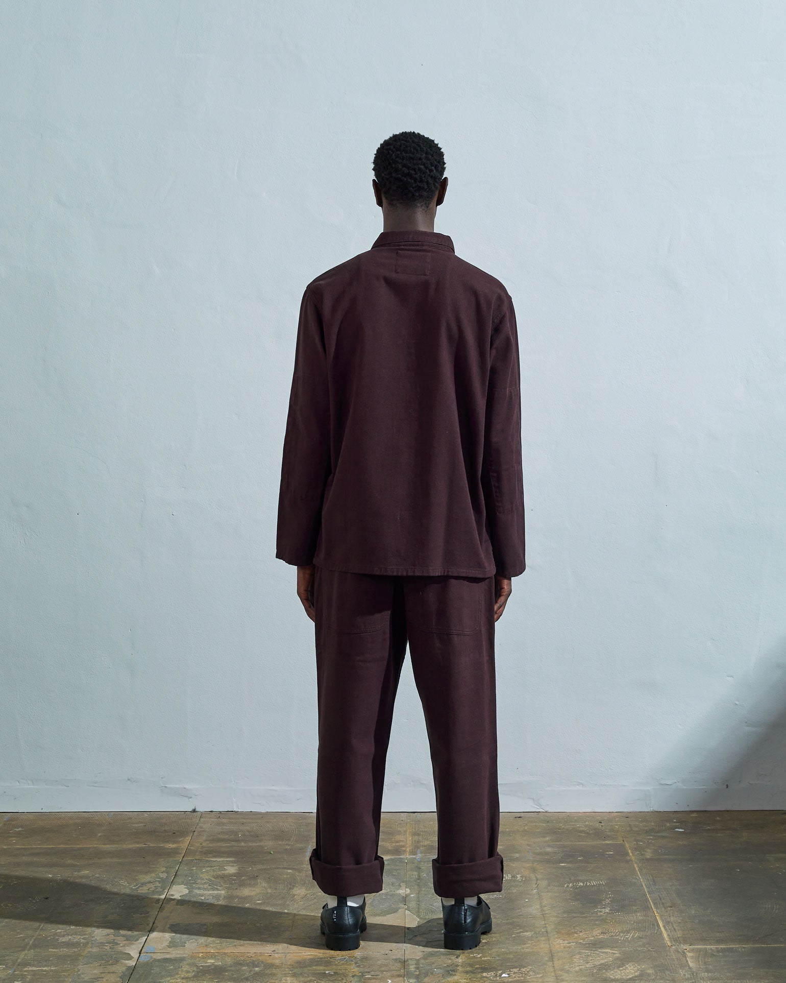 Full-length rear view of #3001, dark plum-coloured organic cotton-drill over shirt with reinforced elbows.