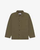 Front flat shot of dark taupe, buttoned organic cotton overshirt. Clear view of chest and hip pockets, corozo buttons and Uskees branding label.