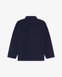 Reverse of deep indigo buttoned organic cotton corduroy overshirt from Uskees. Showing reinforced elbows and boxy silhouette.