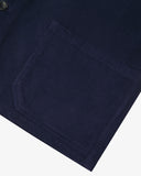 The 3001 Uskees button-down corduroy overshirt in deep indigo, with focus on the cuff, hip pockets and corozo buttons.