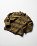 Angled and ruffled flat shot of woodland green check, buttoned Pennine wool overshirt.