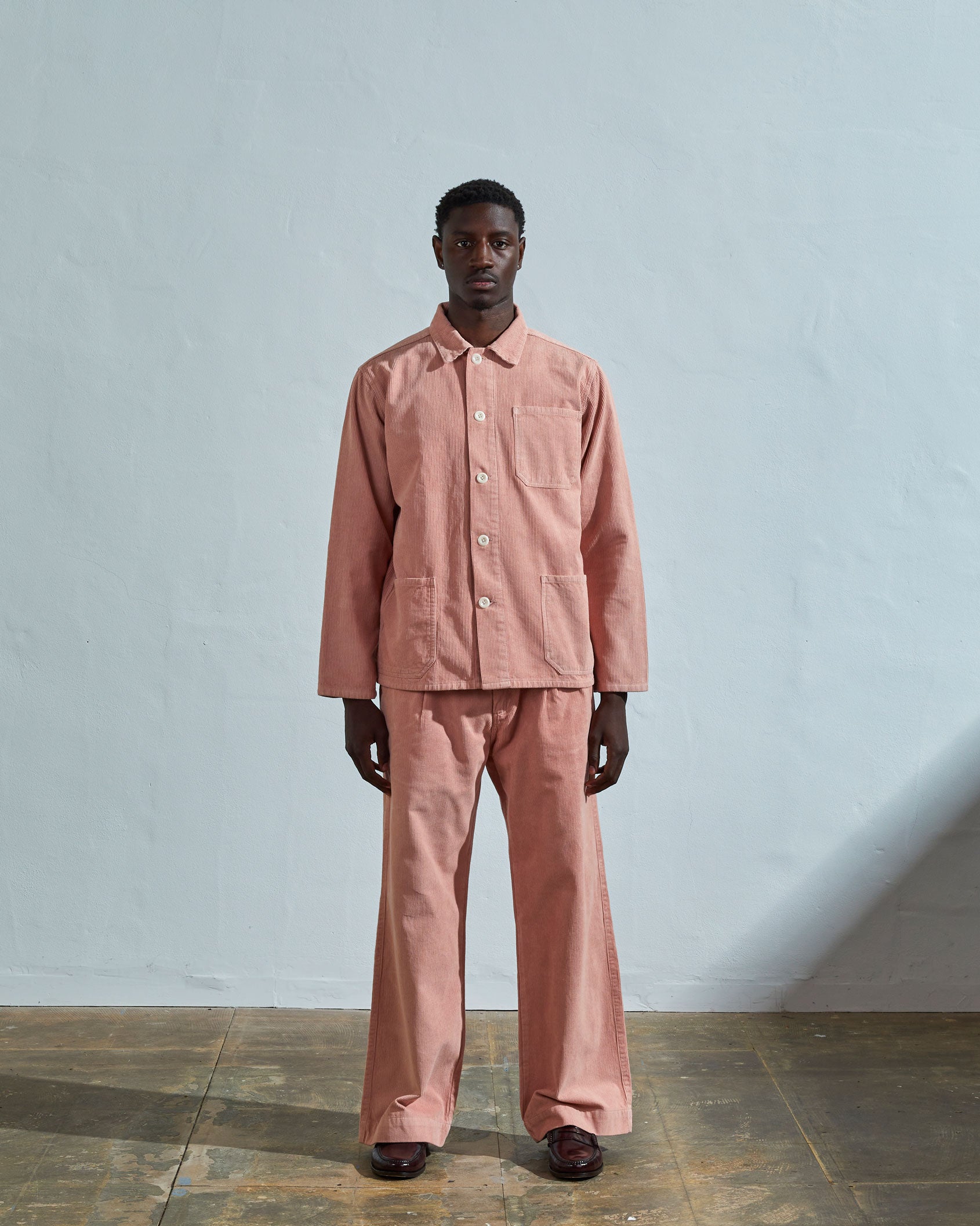 Full-length front view of model wearing #3001, dusty pink corduroy overshirt paired with matching Uskees cord pants.