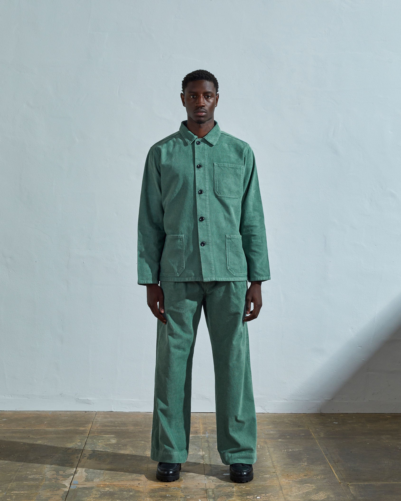 Full-length front view of model wearing  #3001, eucalyptus corduroy overshirt paired with matching Uskees eucalyptus-green cord pants.