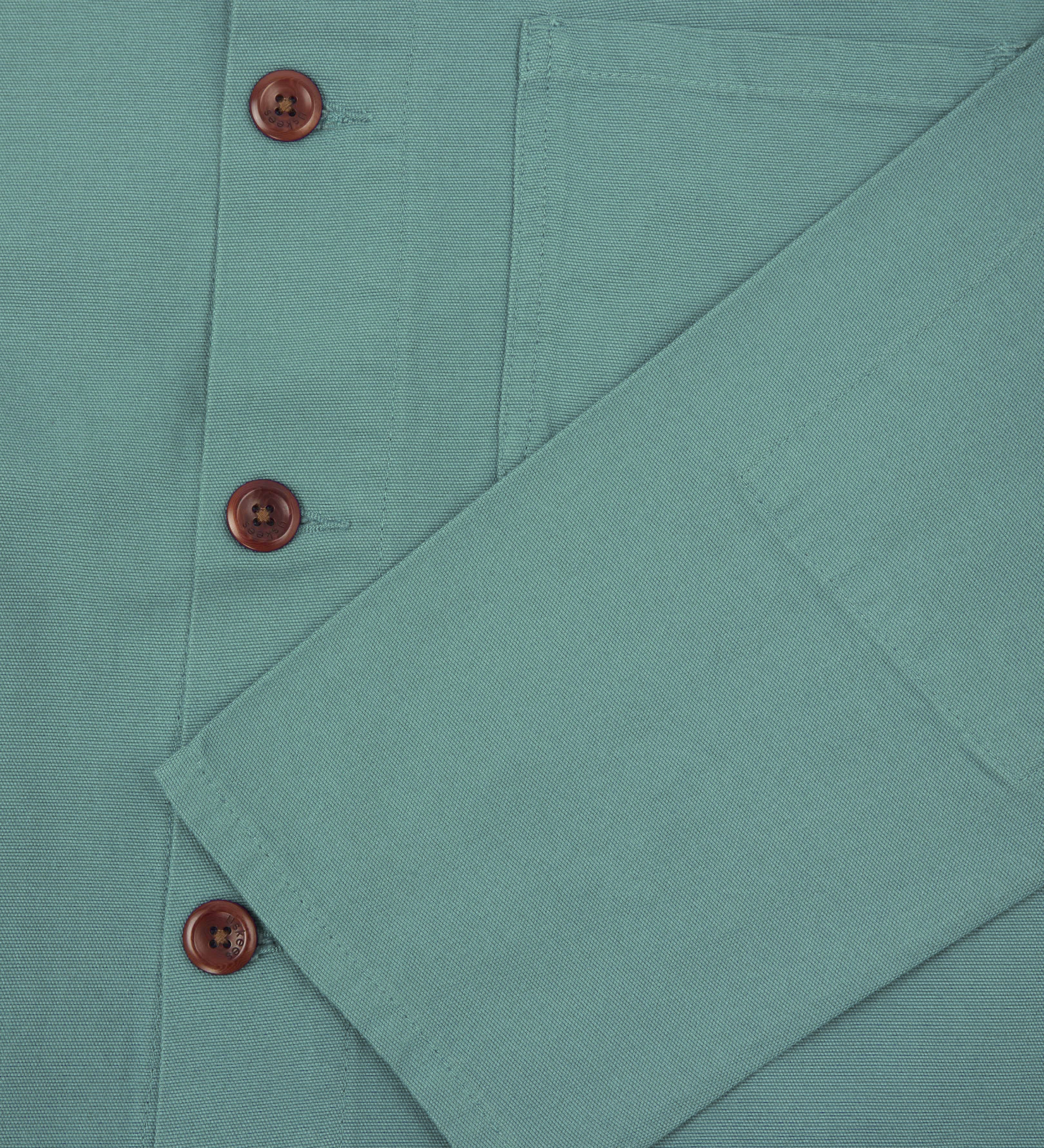 Close up shot of uskees eucalyptus green men's overshirt showing corozo buttons