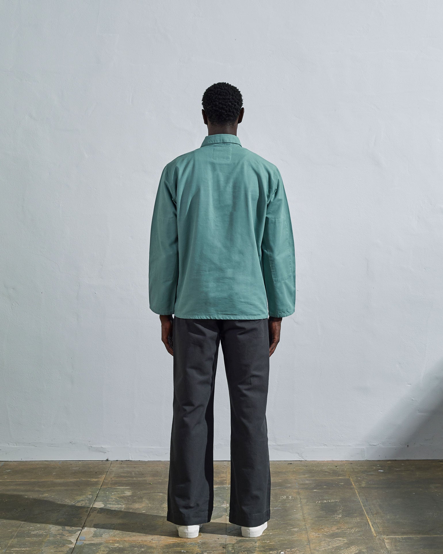 Full-length reverse wearing #3001, 'blue-green 'eucalyptus' organic cotton over shirt with view of reinforced elbows and boxy silhouette.