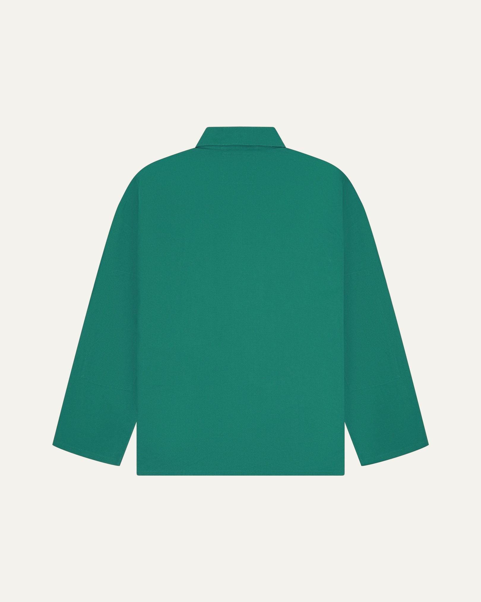 Back view of foam green, buttoned organic cotton overshirt with view of reinforced elbow area and boxy silhouette.