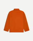 Back view of golden-orange, buttoned organic cotton overshirt with view of reinforced elbow area and boxy silhouette.