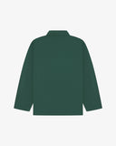 Back view of green, buttoned organic cotton overshirt with view of reinforced elbow area and boxy silhouette.