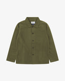 Front flat shot of olive green, buttoned ripstop overshirt. Clear view of chest and hip pockets, corozo buttons and Uskees branding label.