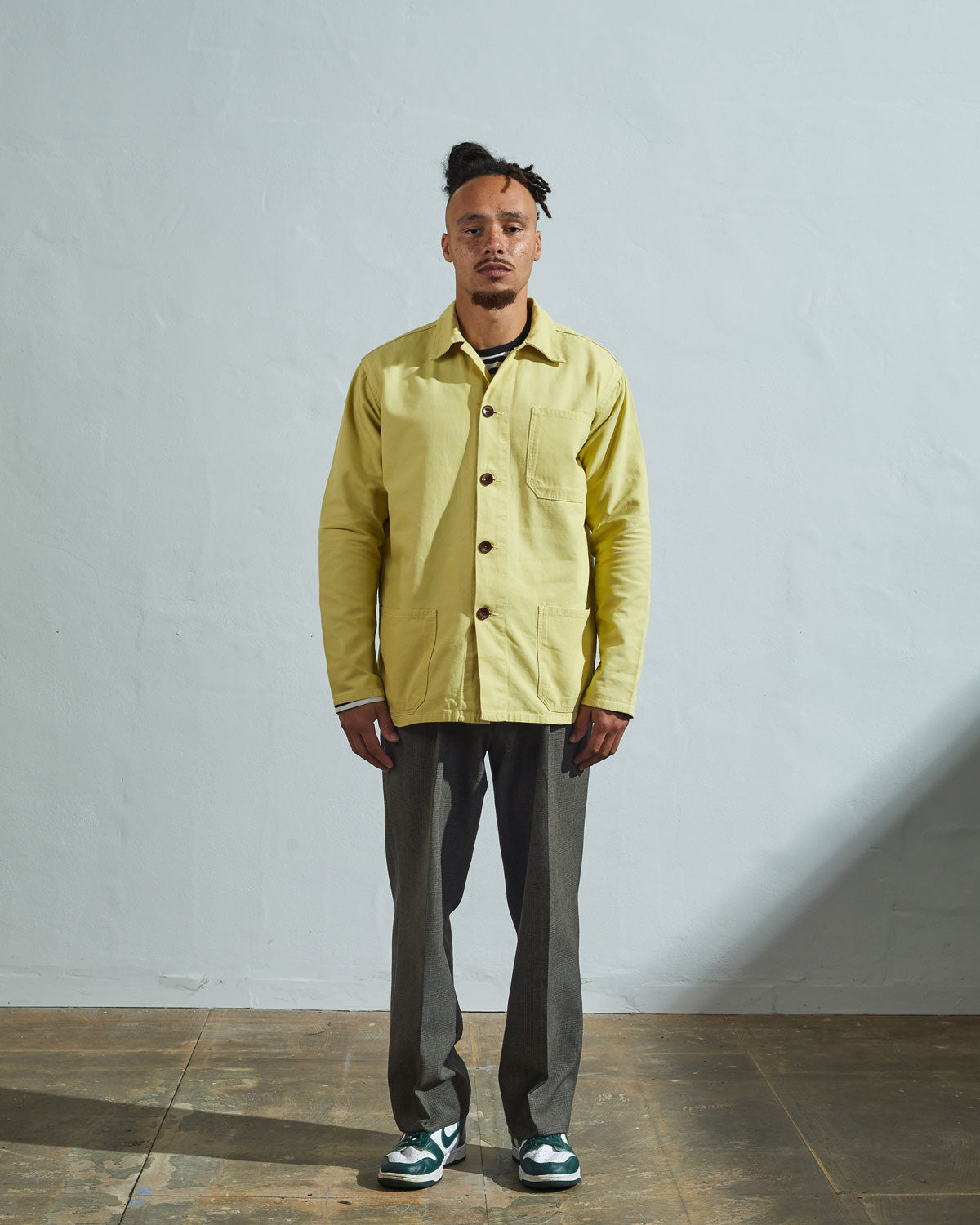 Full-length front view of model wearing #3001, lime organic cotton overshirt paired with matching Uskees lime cord pants.