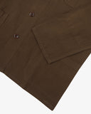 The 3001 Uskees button-down linen blend overshirt in brown, with focus on the cuff, hip pocket, reinforced elbow and corozo buttons.
