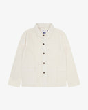 Front flat shot of off-white, buttoned linen blend overshirt. Clear view of corozo buttons, 3 pockets and Uskees branding label.