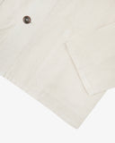 The 3001 Uskees button-down linen blend overshirt in off-white, with focus on the cuff, hip pocket, reinforced elbow and corozo buttons.