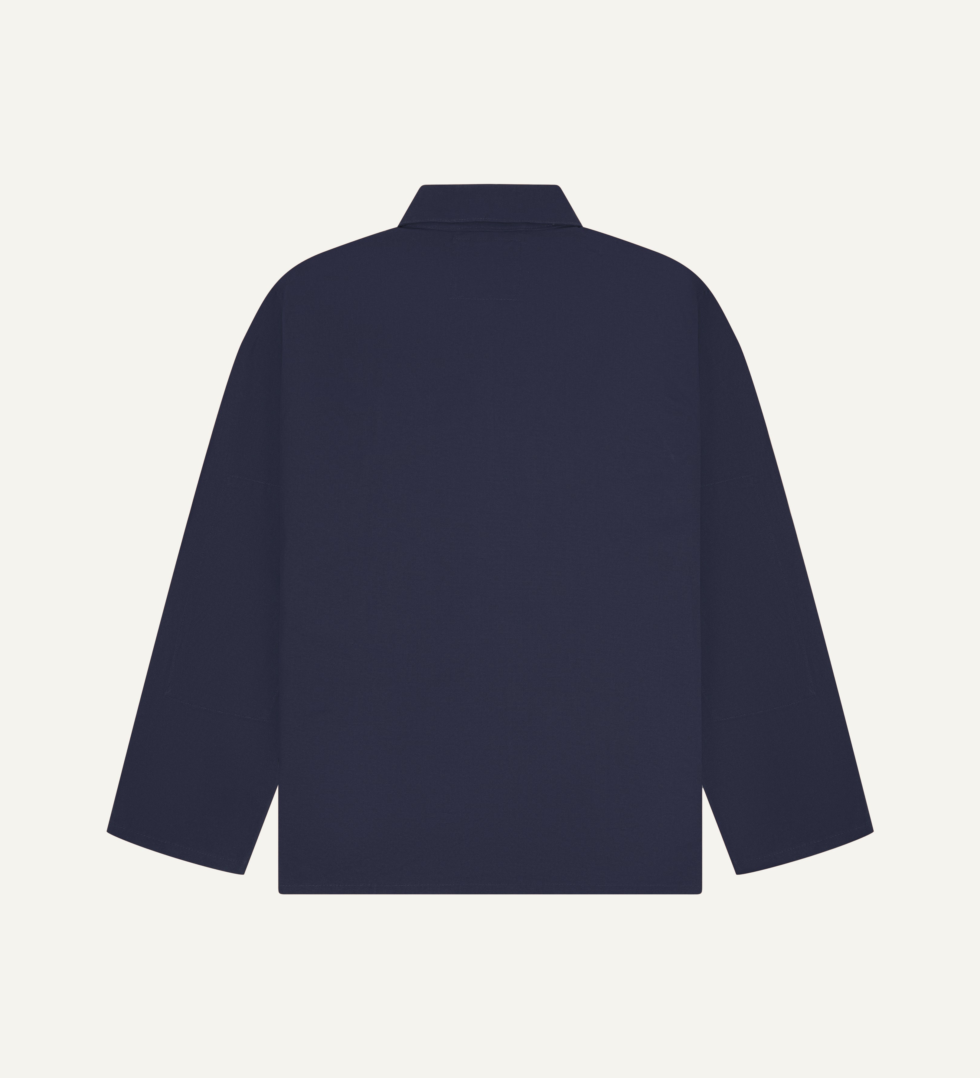 Back view of midnight blue, buttoned organic cotton overshirt with view of reinforced elbow area and boxy silhouette.