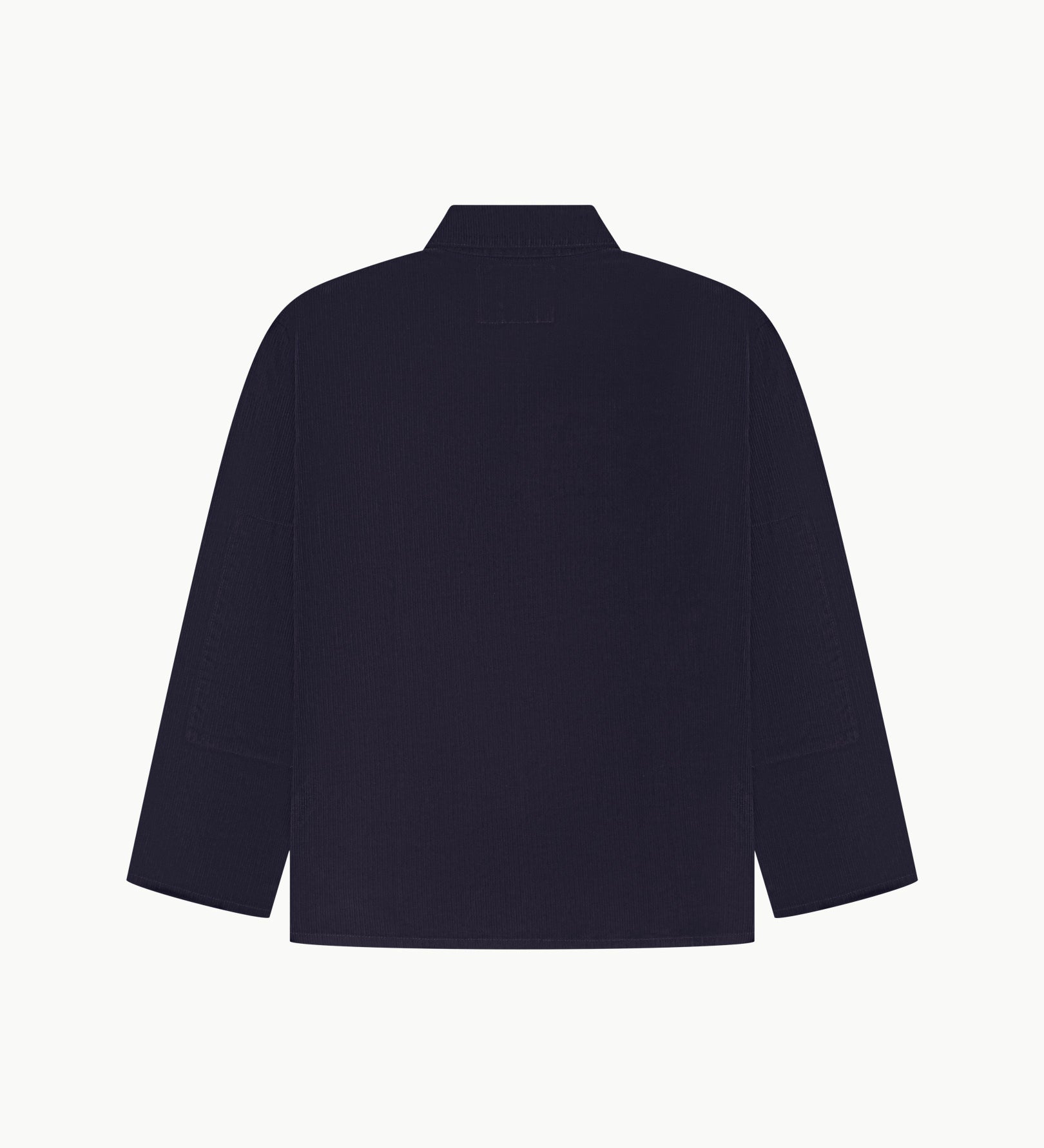 Back view of midnight blue, buttoned corduroy overshirt with view of reinforced elbow area and boxy silhouette.