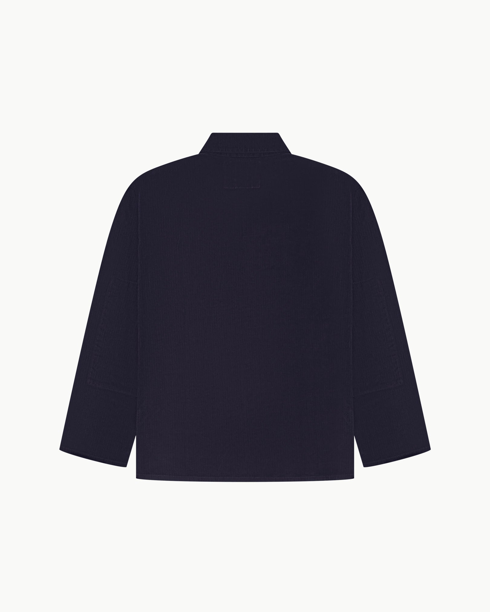 Back view of midnight blue, buttoned corduroy overshirt with view of reinforced elbow area and boxy silhouette.