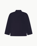 Back view of midnight blue, buttoned corduroy overshirt with view of reinforced elbow area and boxy silhouette.