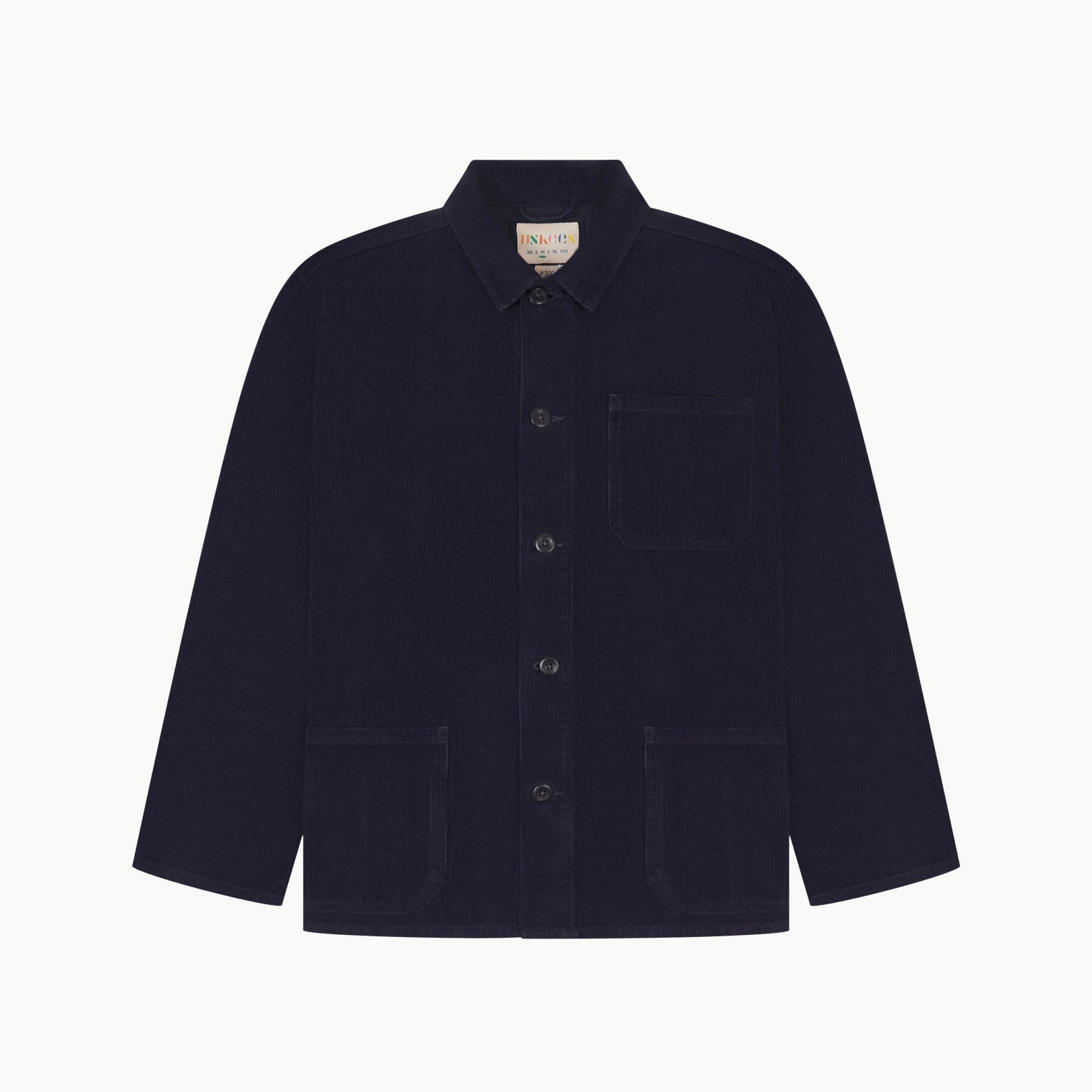 Front flat shot of midnight blue, buttoned corduroy overshirt. Clear view of chest and hip pockets, corozo buttons and Uskees branding label.