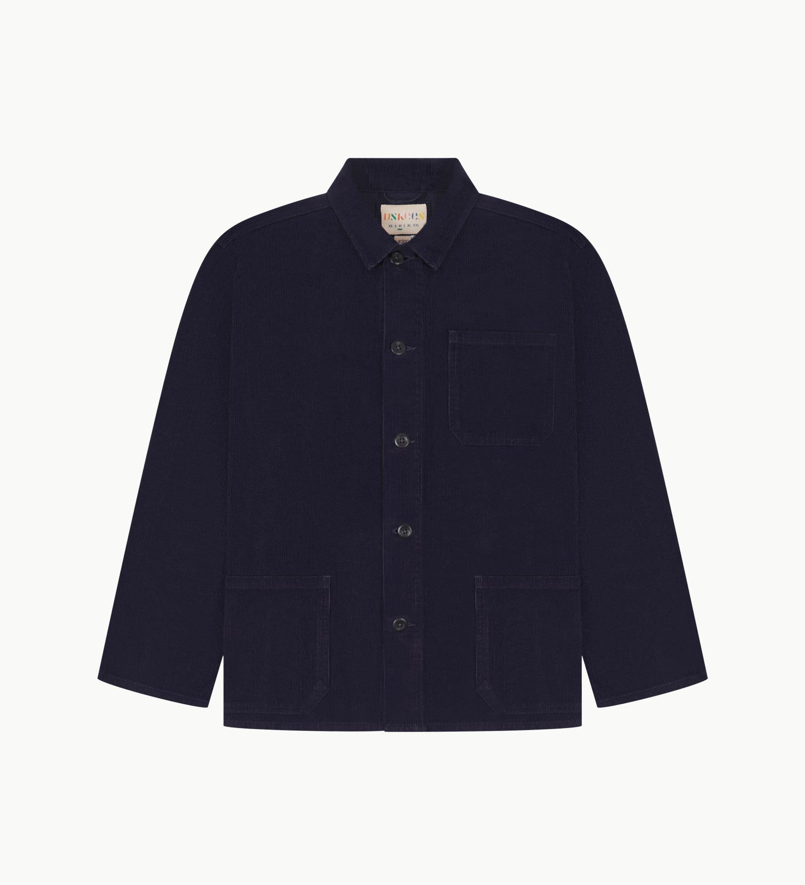 Front flat shot of midnight blue, buttoned corduroy overshirt. Clear view of chest and hip pockets, corozo buttons and Uskees branding label.
