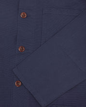 Close shot of uskees midnight blue organic cotton overshirt - sleeve and front button detail.