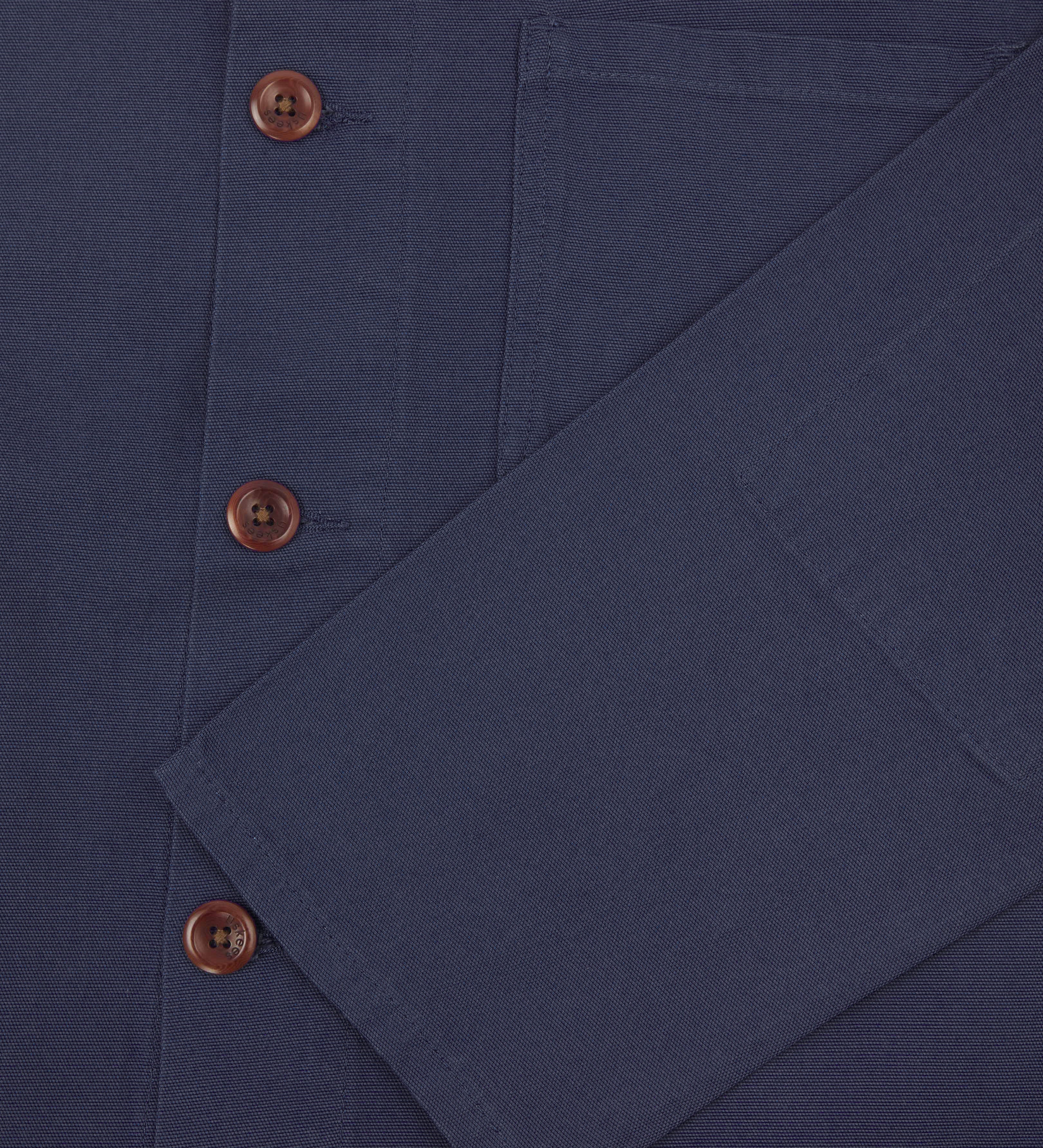 Close shot of uskees midnight blue organic cotton overshirt - sleeve and front button detail.
