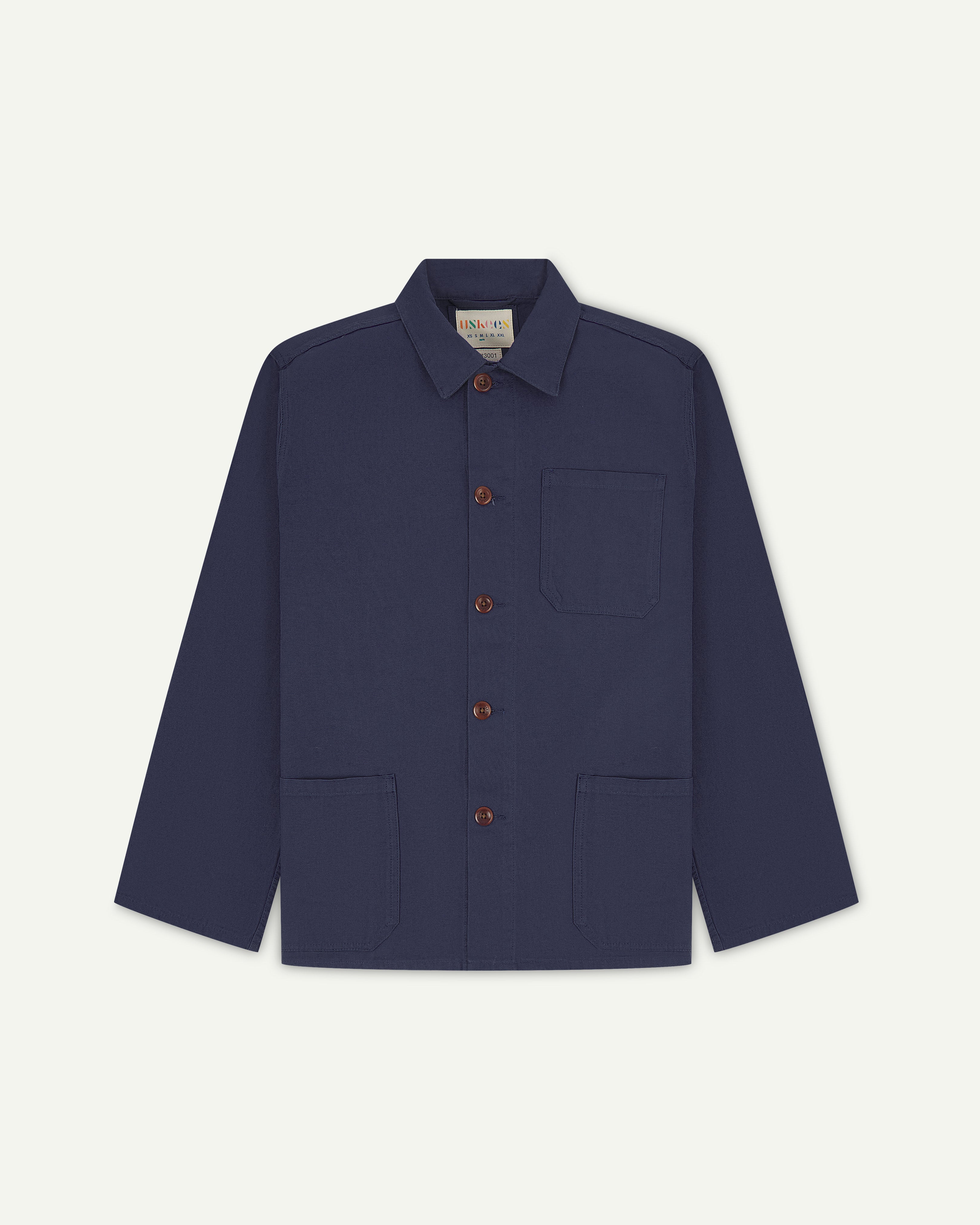 Front flat shot of midnight blue men's overshirt with buttons done up and showing uskees neck label