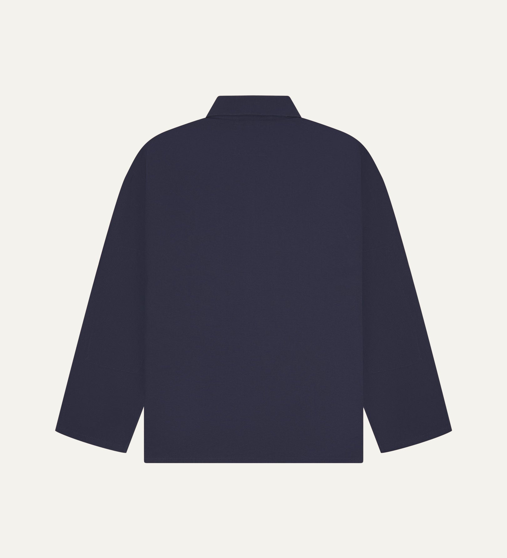 Back view of midnight blue, buttoned organic cotton overshirt with view of reinforced elbow area and boxy silhouette.