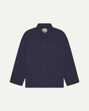 Front flat shot of midnight blue, buttoned organic cotton overshirt. Clear view of chest and hip pockets, corozo buttons and Uskees branding label.